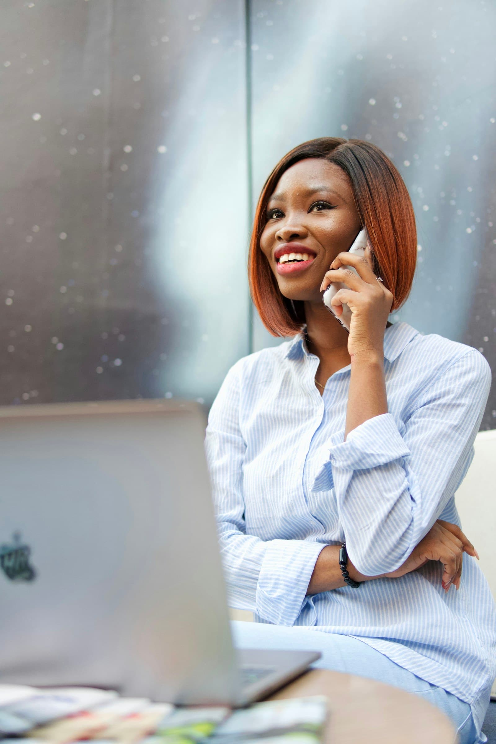Smiling young woman speaking on the phone